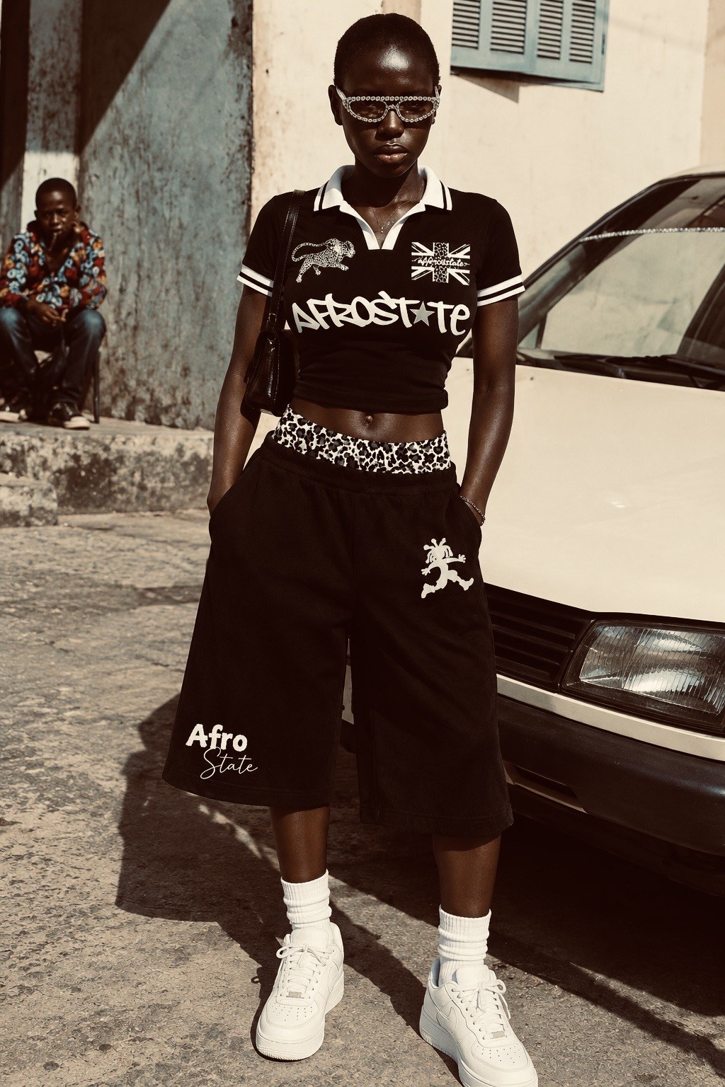 Model in black AFROSTATE street jorts with a leopard-print waistband, styled with the black jersey crop tee
